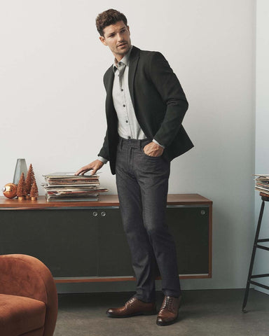 A man dressed in business-casual attire in his office