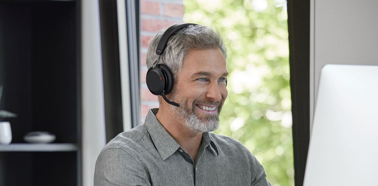A person using Jabra evolve2 headphones in a personal workspace environment