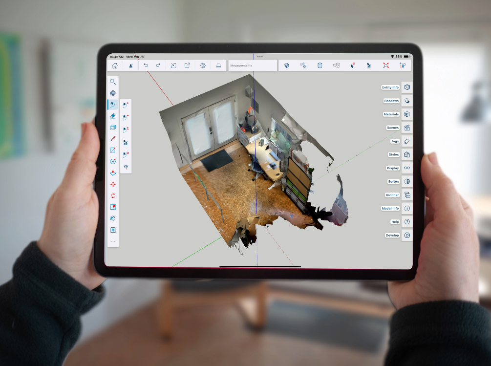 Hands holding an iPad showing a scan in SketchUp