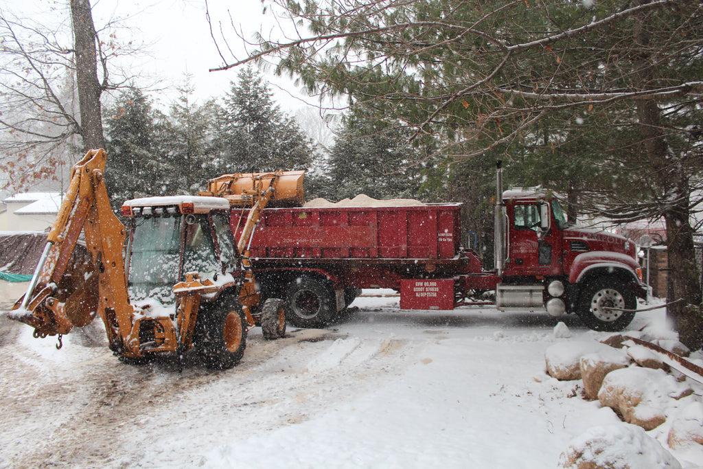 Loading our Mack roll-off with salt to be applied by our dedicated salt spreaders.