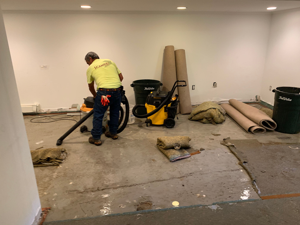 J. Campoli & Sons removes damaged carpet and subfloor after flooding.