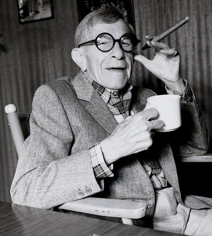 George Burns holding a cup and a cigar