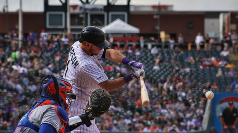 A baseball player swings his bat