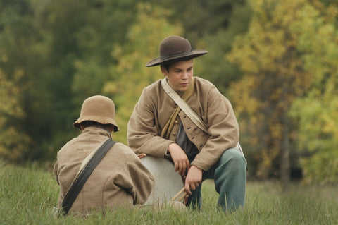 Two young Civil War reenactors in a field dreaming of unique greeting cards for her