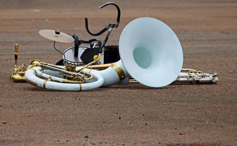 Marching band instruments lay in a heap on the street