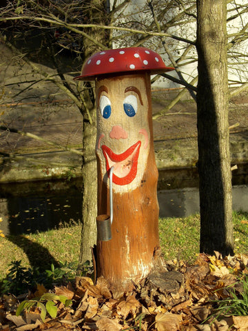 A tree trunk is painted like a mushroom. It's creepy, dude. funny birthday cards for dad