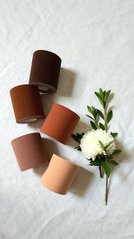 Rolls of boob tape in various shades of brown