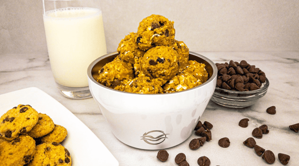 White Calicle bowl filled with cookie dough energy bites
