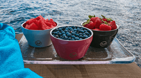 Pink, black and white Calicle bowls filled with watermelon, raspberries and blueberries