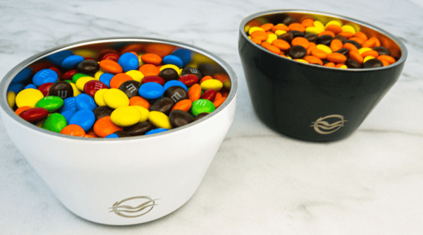 Black and white Calicle bowl filled with M&M's and Reese's Pieces