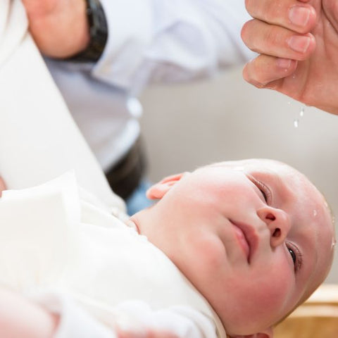 bebelus in timpul slujbei de botez
