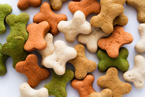 Multi-colored dog treats in the shape of bones.