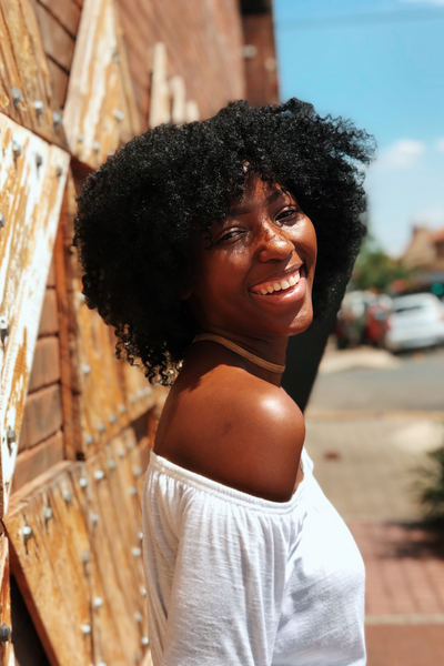 Black girl smiling with short afro hair