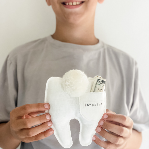 boy loses tooth and receives money in his tooth fairy pillow