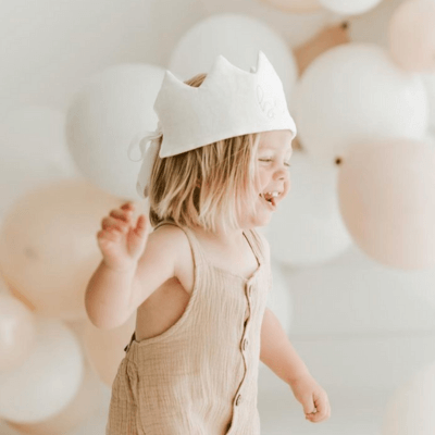 toddler wearing a first birthday crown