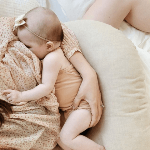 mom breastfeeding baby on boppy pillow