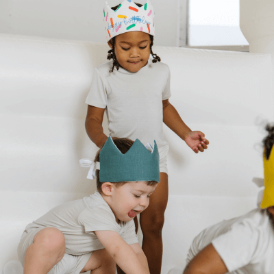 kids wearing birthday crowns at  party