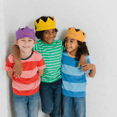 3 boys wearing customizable crowns with words of affirmation