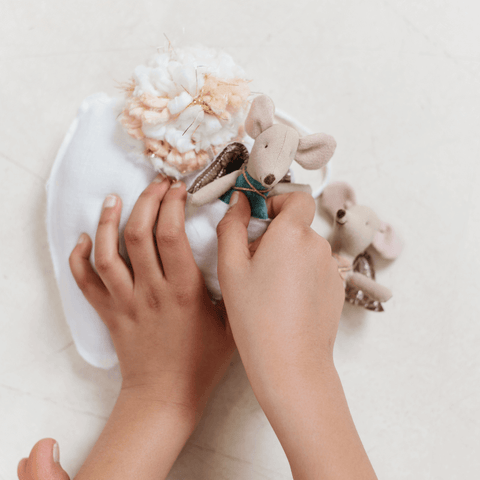 child playing with tooth fairy pillow with a pocket from madly wish