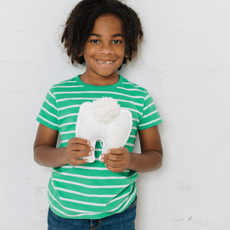 boy holding a tooth fairy pillow from Madly Wish on Etsy