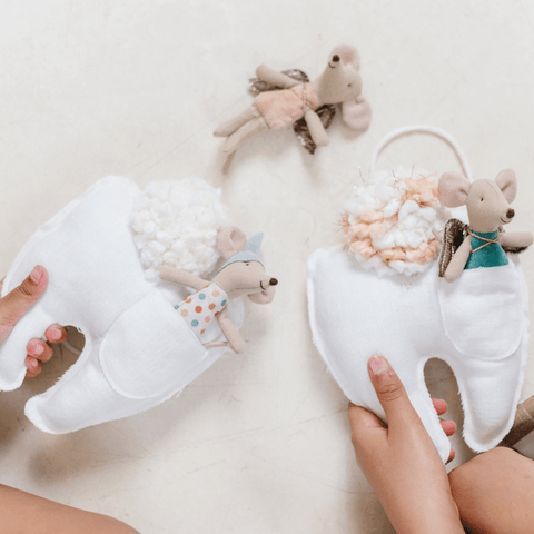 kids holding the best tooth fairy pillows from Madly Wish