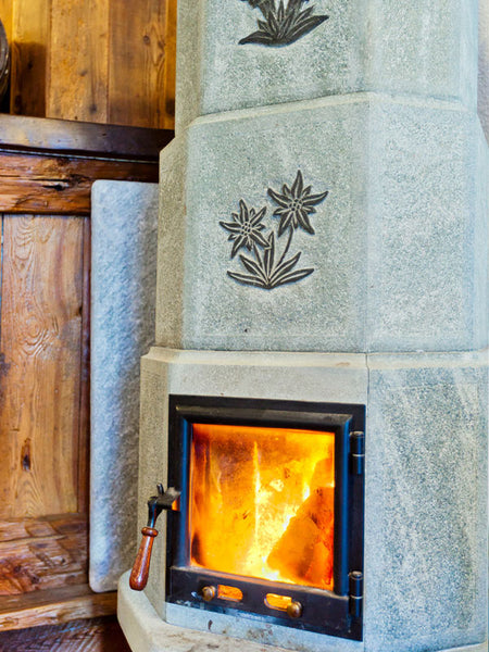 A carved fireplace made from soapstone.