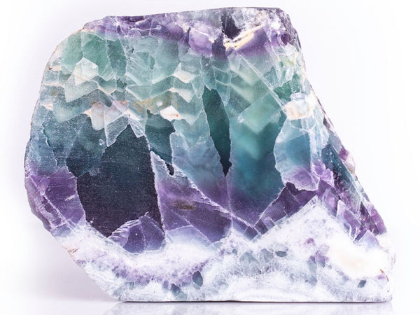 A Purple Fluorite crystal with blue and green Fluorite in the center