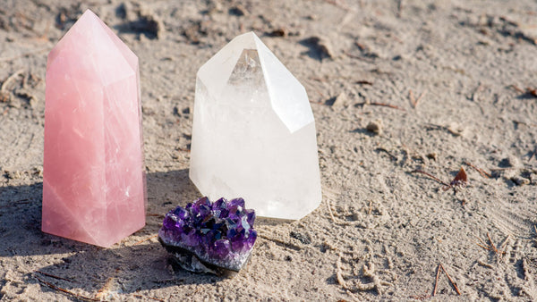 Clear Quartz beside Rose Quartz and amethyst, often used in combination to amplify manifestations of love.