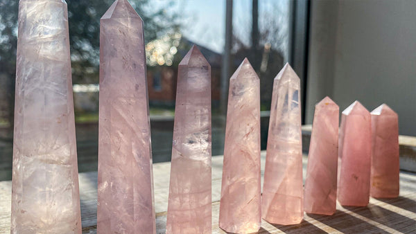An Example of unpolished Rose Quartz towers in a windowsill showing how to charge rose Quartz crystals.