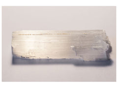 a white selenite stick on a table