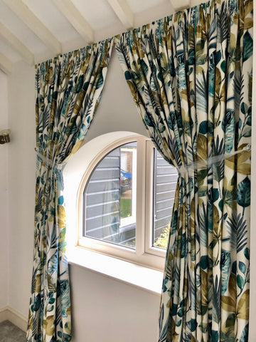 pencil pleat curtains on arched window