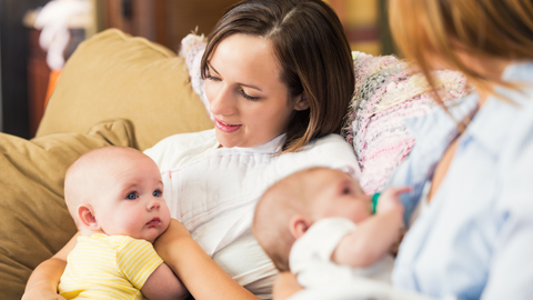 mom breastfeeding with friends