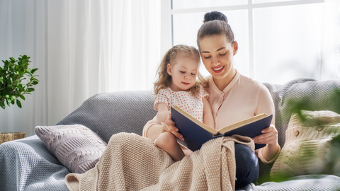 mom reading baby book to child