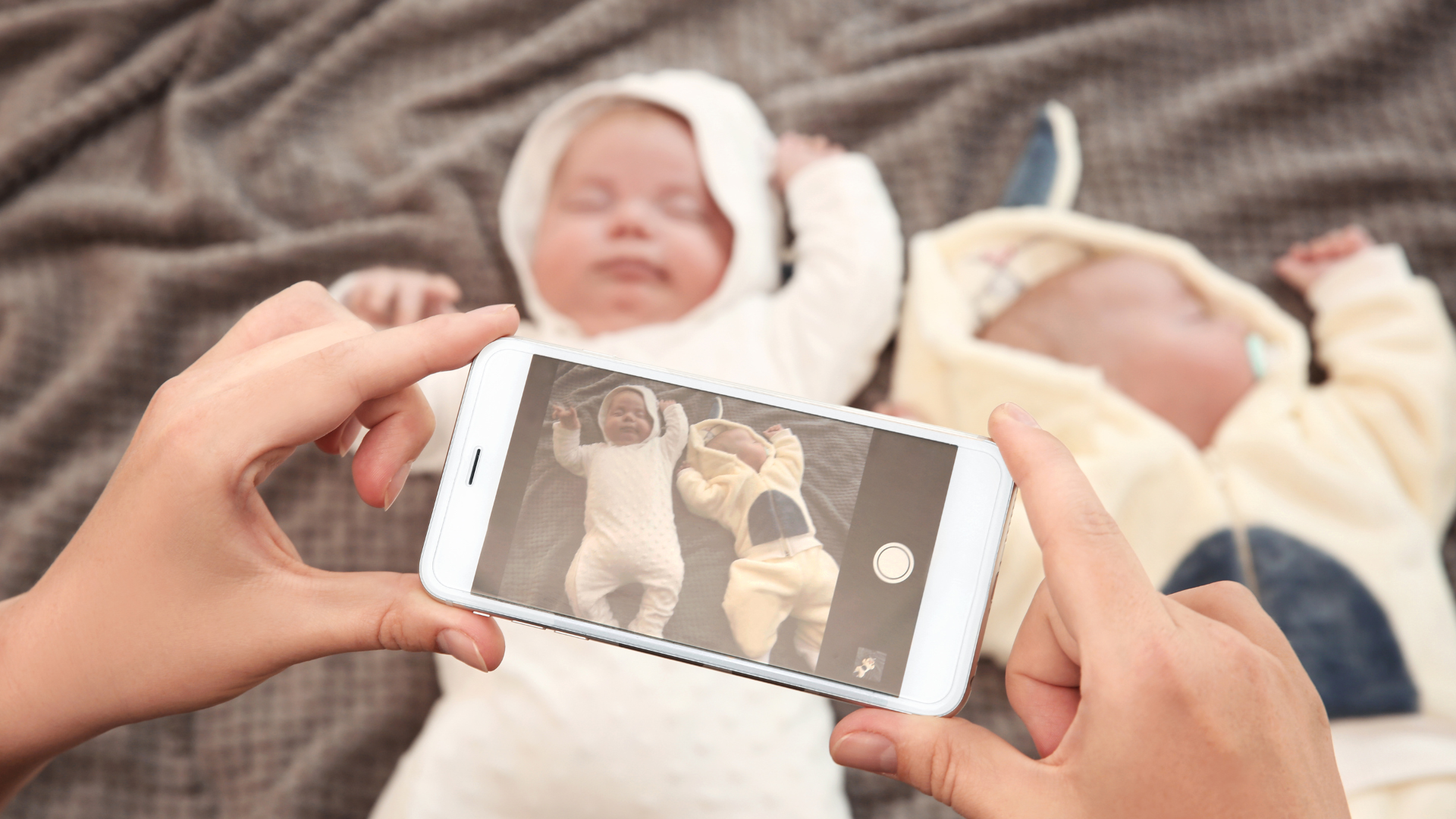 mom taking photo of baby in bunny outfit