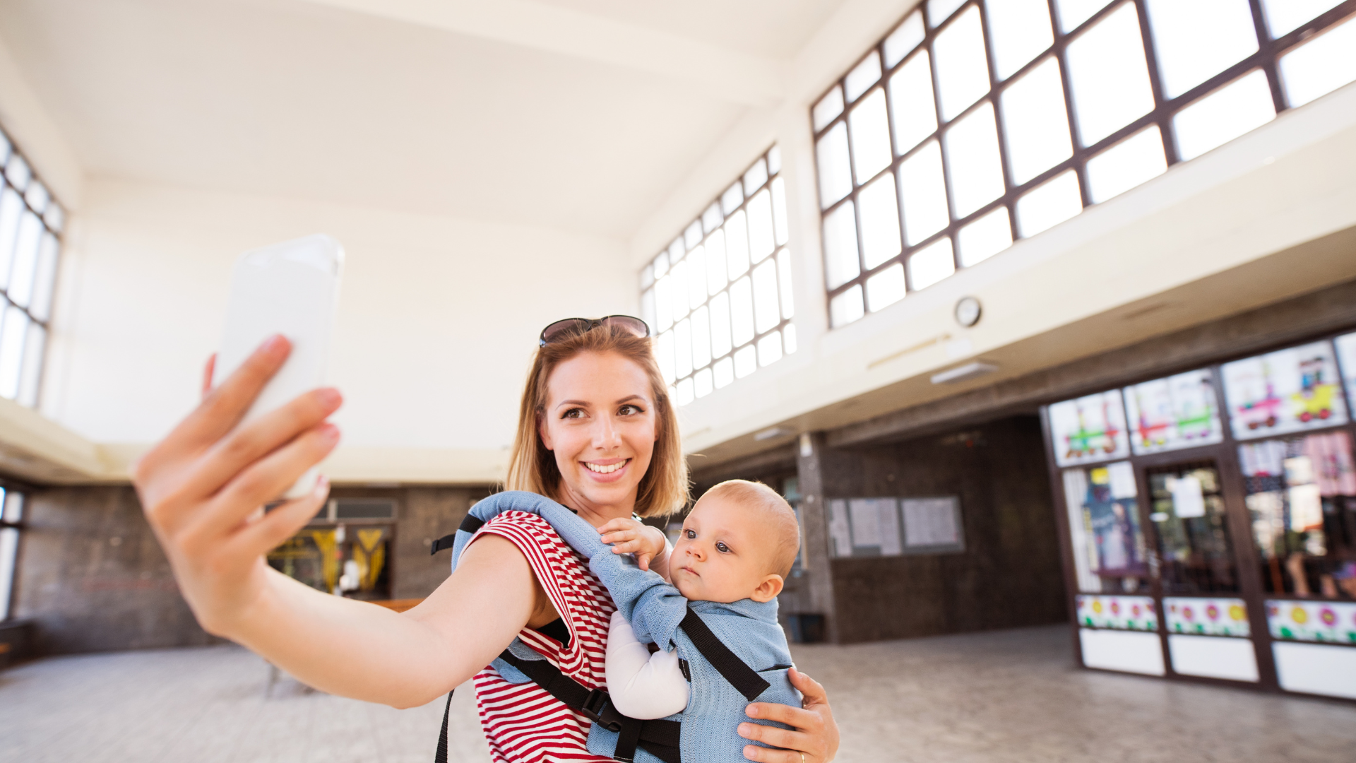 mom taking a selfie with baby in carrier