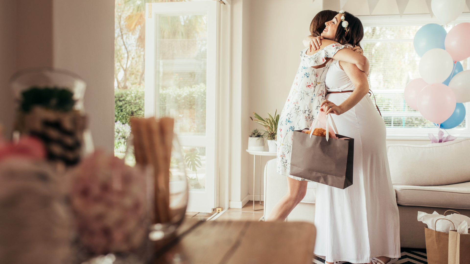 friends hugging at baby shower