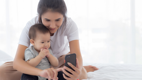 mom capturing baby milestones on digital baby book app