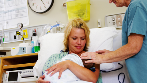 mom holding baby for first time after birth