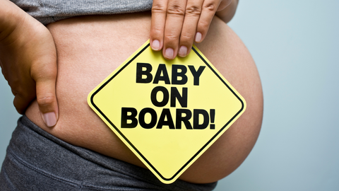 pregnant lady with baby on board sign