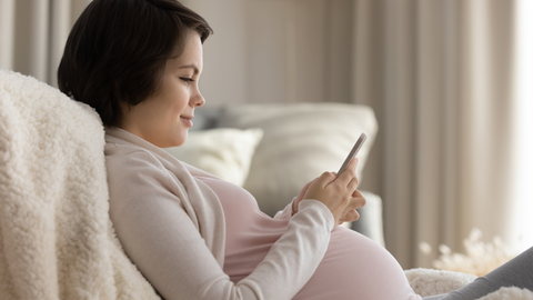 pregnant woman using digital baby book app