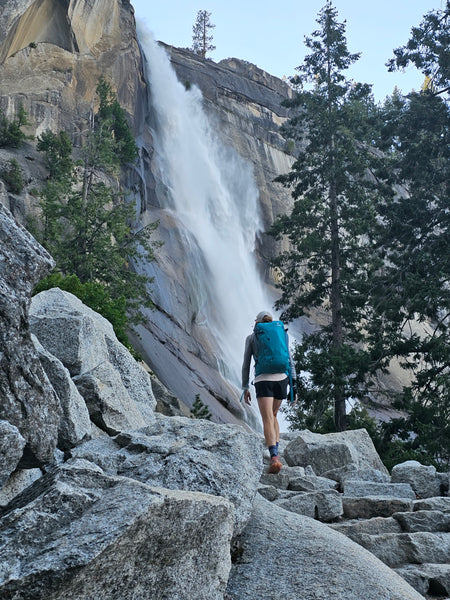 person hiking with nevada falls in background
