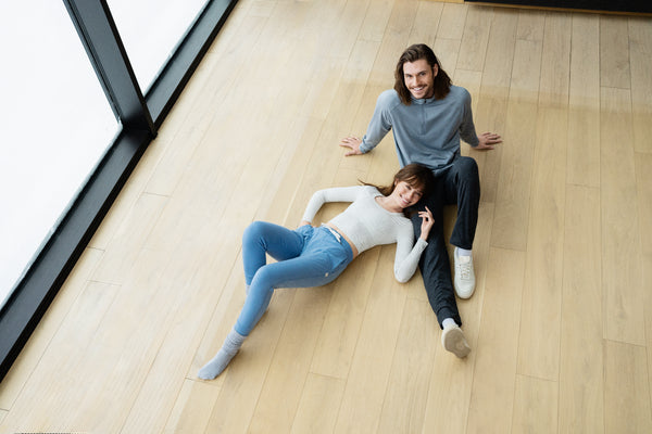 two people laying on the floor in vuori outfits