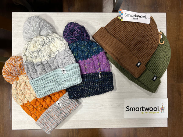 Smartwool beanies on a table