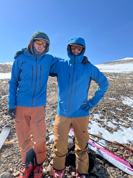 two men wearing matching ski outfits