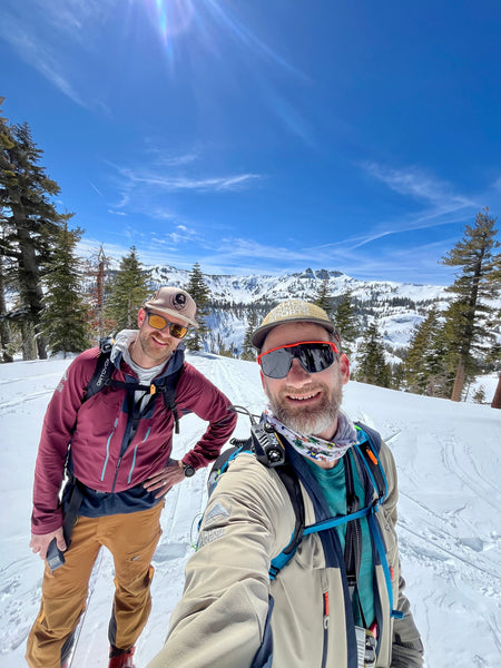 selfie of two men enjoying a sunny ski day