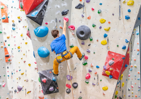 man climbing indoors at a climbing gym