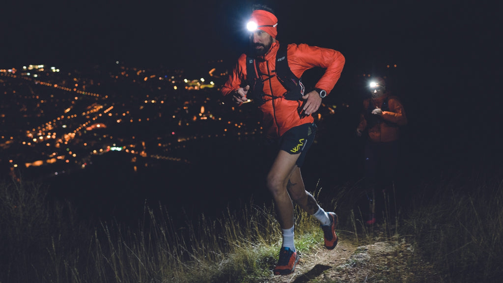 guy running in the dark with a headlamp
