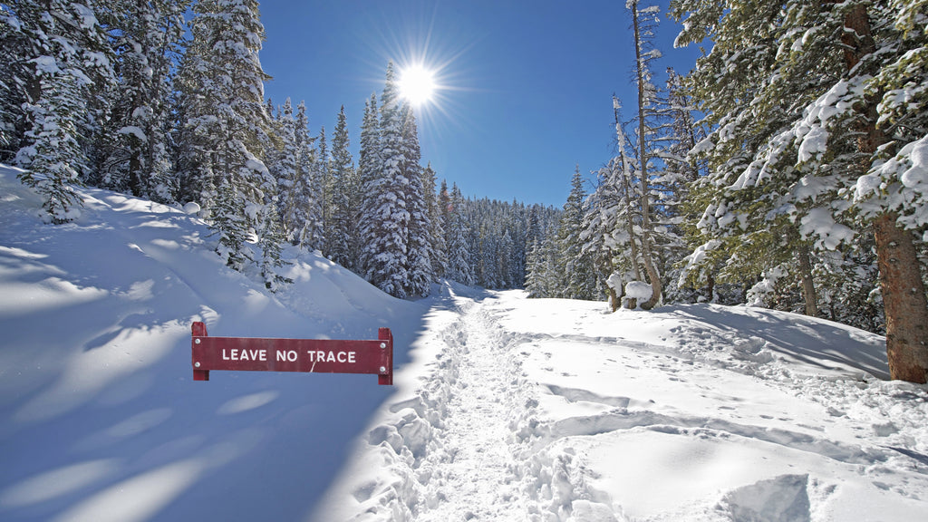 leave no trace sign on snowy trail