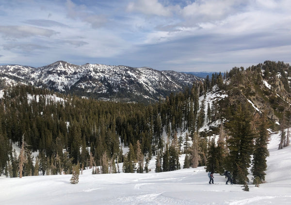 two people ski touring uphill