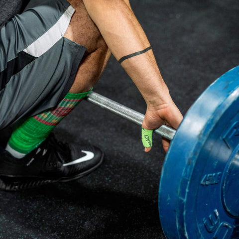 athlete setting up on barbell with weightlifting hook grip